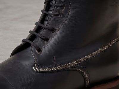 Professional shoe repair process with tools and leather boot restoration